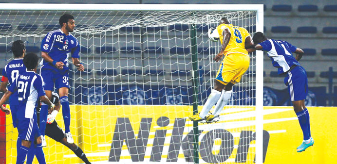 Djibril Cisse (C-R) of Qataru2019s Al Gharafa scores against  UAEu2019s Al Nasr during theirAFC Champions League match in in Dubai yesterday.