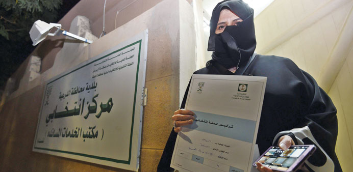 Aljazi al-Hussaini, a candidate for the municipal council in the town of Diriyah, on the outskirts of Riyadh, shows an electoral campaign licence issu