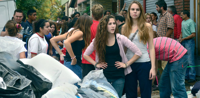 Volunteers arrange donated clothes before giving them out to the victims of a powerful storm that slammed La Plata earlier this week.