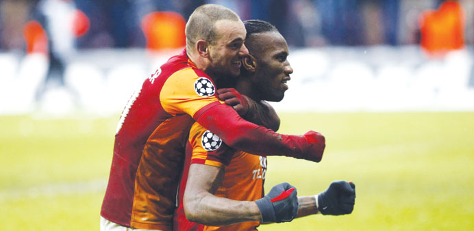 Galatasarayu2019s Wesley Sneijder (left) and Didier Drogba celebrate their victory over Juventus after their Champions League match in Istanbul yesterday.