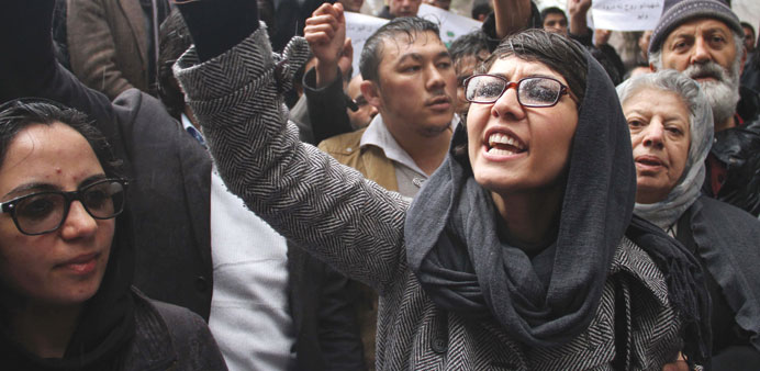Afghan people shout slogans as they condemn the killing of 21 Afghan National Army (ANA) soldiers during a protest in Kabul yesterday.
