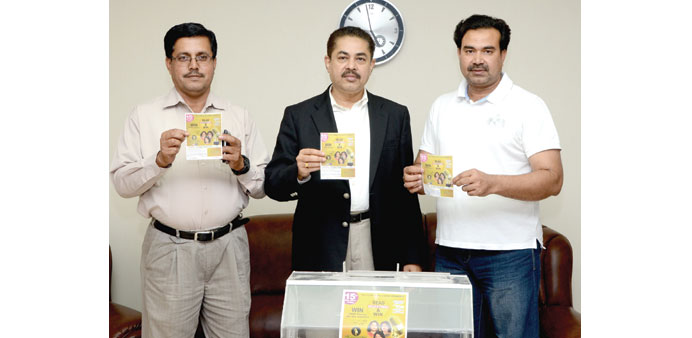 Organisers and James John holding winning coupons.
