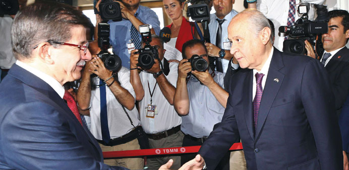 Turkeyu2019s Prime Minister Ahmet Davutoglu (left) meets Nationalist Movement Party (MHP) opposition leader Devlet Bahceli in Ankara yesterday.