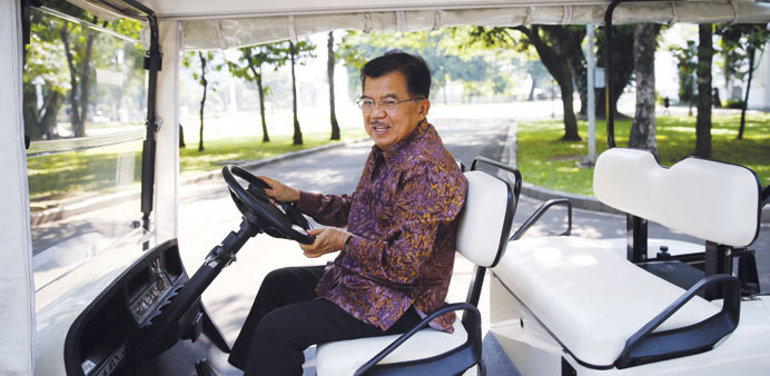 Indonesiau2019s Vice President Jusuf Kalla drives a golf cart after an interview at the vice presidential palace compound in Jakarta yesterday.