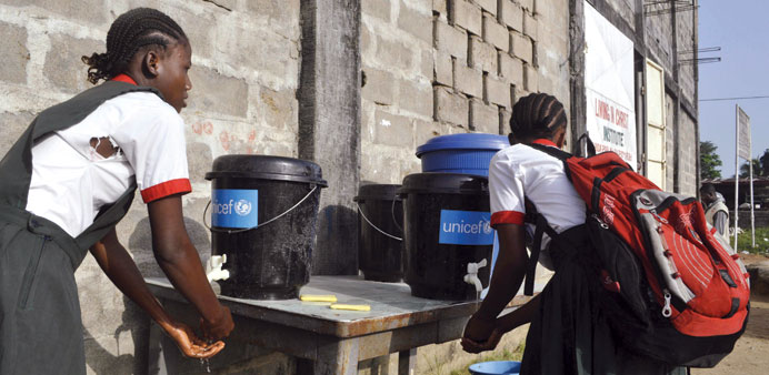 A girl wash her hands at a school in Paynesville, Liberia.