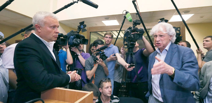 Lebedev (left) listens as his lawyer Reznik talks to journalists after the court hearing at the Ostankinsky district court in Moscow.