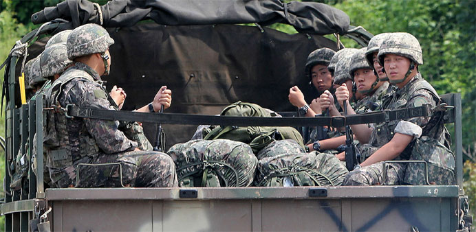 South Korean soldiers ride in the back of a military vehicle in the border county of Yeoncheon 