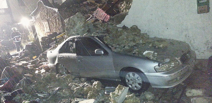 A car is covered in rubble from the wreckage of the TransAsia Airways flight on Taiwanu2019s offshore island of Penghu.