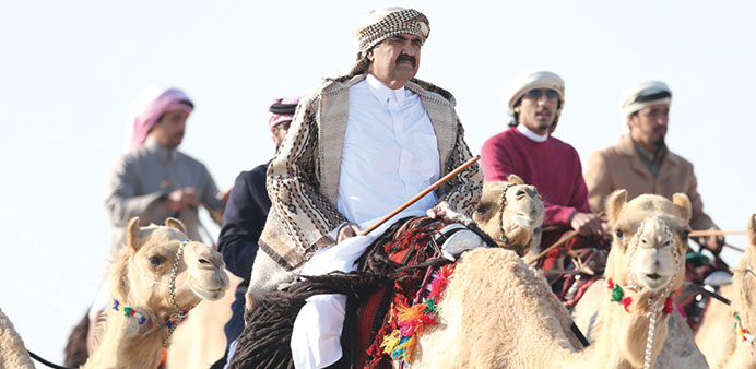HH the Father Emir Sheikh Hamad bin Khalifa al-Thani riding a purebred Arabian camel at Um Ethnaytein.