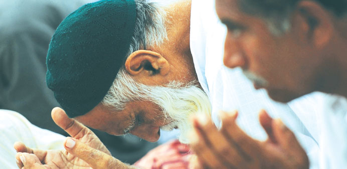 Pakistani pray during the first day of the fasting month of Ramadan in Karachi yesterday.