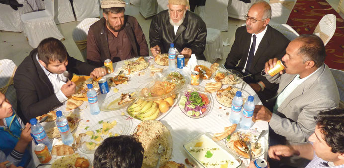 In this photograph taken on May 12, 2015, Afghan well wishers eat during wedding celebrations at a wedding hall in Kabul.