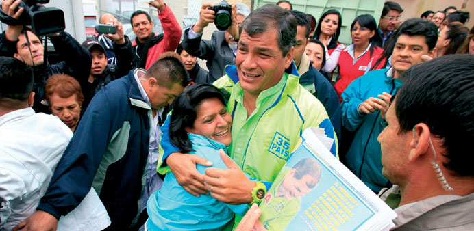 Ecuadorian President and presidential candidate for the up-coming election Rafael Correa (centre) greets supporters during his electoral campaign in Q