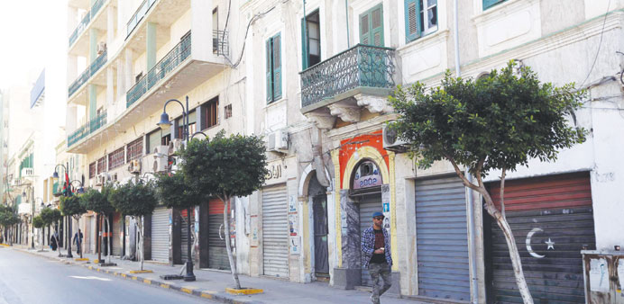  A man walks past closed shops in Tripoli yesterday.