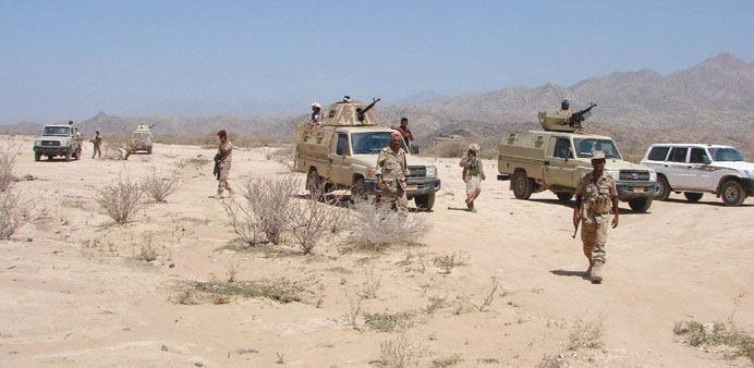 A handout picture made available by the Yemeni defence ministry shows troops taking position during the fight against Al Qaeda militants in the provin