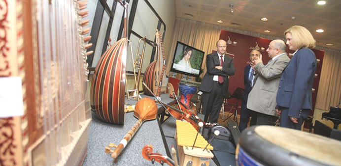 Kelly, al-Heeti and other officials view some of the instruments purchased with the donation.