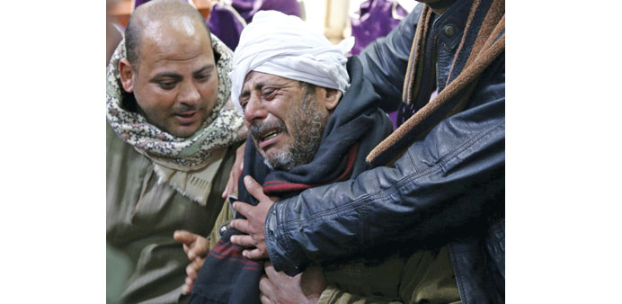  The father of one of the Egyptian Coptic men killed in Libya mourns at a church in Al-Our village in Minya governorate, south of Cairo.