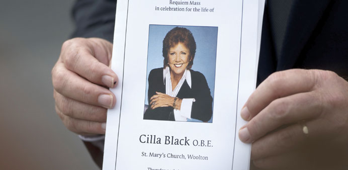 A guest at the funeral of singer and television presenter Cilla Black holds an order of service outside St Maryu2019s Church in Liverpool after her funera