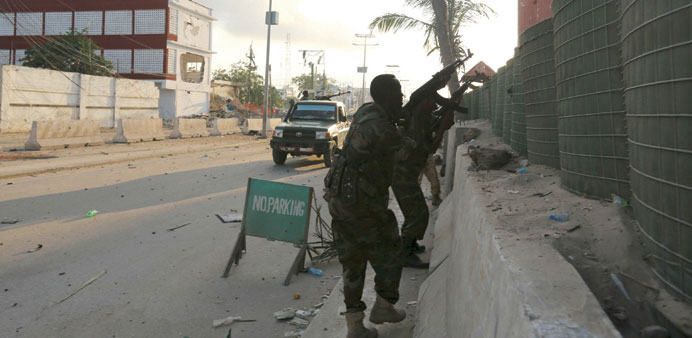 Somali soldiers take up positions outside a hotel in Mogadishu during a firefight with Islamist Shebaab gunmen yesterday.