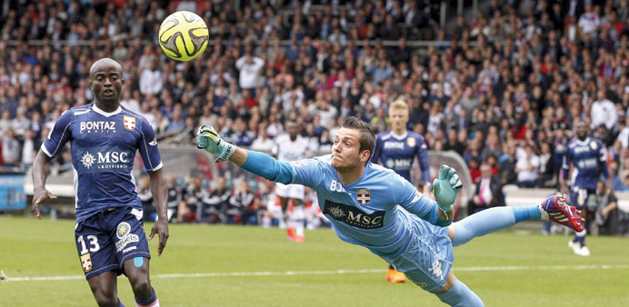 Evianu2019s goalkeeper Benjamin Leroy saves a shot during the French Ligue 1 match against Olympique Lyon at the Gerland stadium in Lyon. (Reuters)