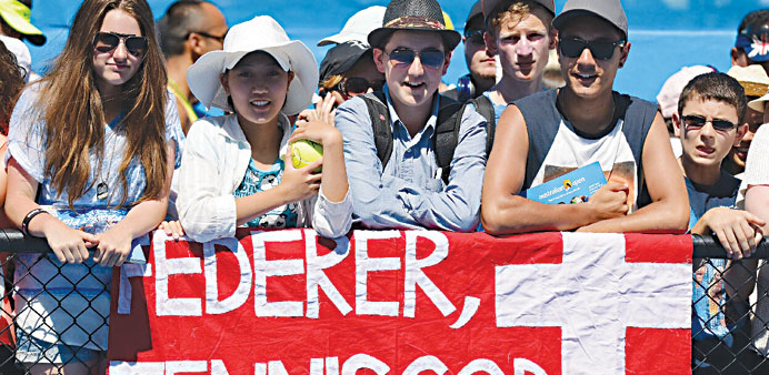 Fans of Switzerlandu2019s Roger Federer display a banner beside a practice court on day three of the Australian Open in Melbourne yesterday. (AFP)