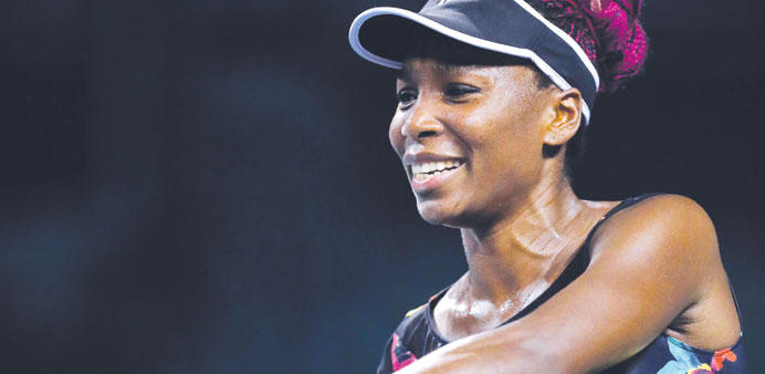 Venus Williams of the US reacts while playing against Simona Halep of Romania during their third round match at the Toray Pan Pacific Open in Tokyo ye