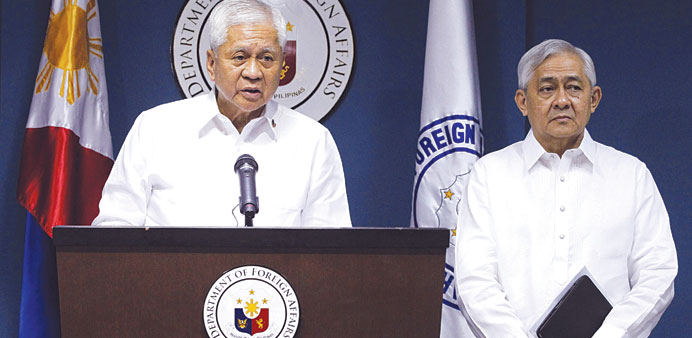 Philippine Foreign Secretary Albert del Rosario (left) stands next to Solicitor General Francis Jardeleza during a news conference in Manila yesterday