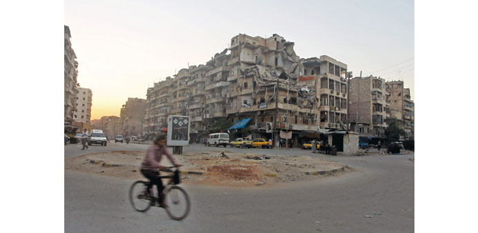 A man rides a bicycle in the Tariq al-Bab neighbourhood of Aleppo yesterday.