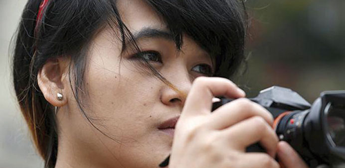 File photo shows Xyza Cruz Bacani, posing with a camera in Macau.