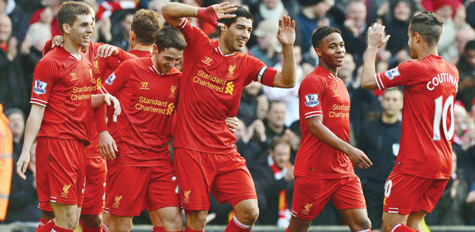 Liverpoolu2019s Uruguayan striker Luis Suarez (3 right) celebrate with teammates after scoring a goal against Cardiff City during their English Premier Le