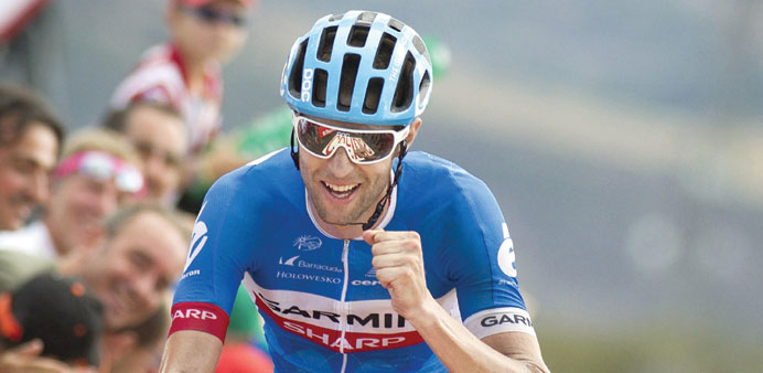 Garmin Sharpu2019s Canadian cyclist Ryder Hesjedal celebrates as he crosses the finish line to win the 14th stage of the 69th edition of u201cLa Vueltau201d Tour 