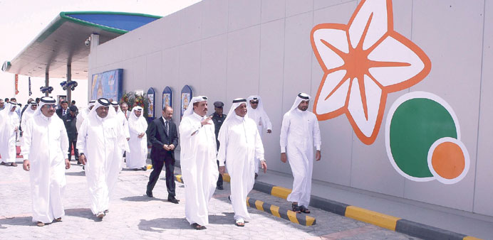 HE Abdullah bin Hamad al-Attiyah and other officials taking a tour of the newly-opened service station.