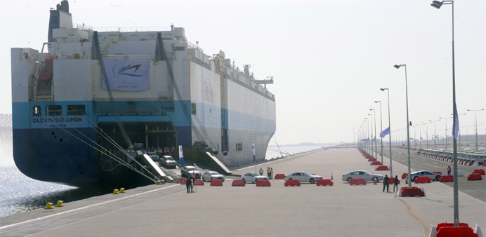 New vehicles are unloaded from a ship at the Hamad Port 