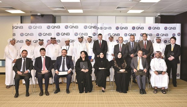 QNB officials with some of the graduates of its  u2018Management Development Programmeu2019.
