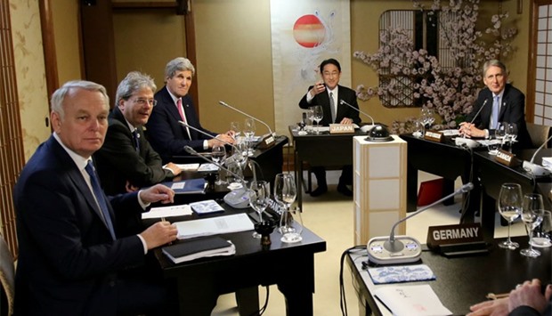 Japanese Foreign Minister Fumio Kishida (2nd R) with French Foreign Minister Jean-Marc Ayrault (L), Italian Foreign Minister Paolo Gentiloni (2nd L), US Secretary of State John Kerry (3rd L) and Canadian Foreign Minister Stephane Dion (R) during their third session of the G7 Foreign Ministers' meeting in Miyajima.