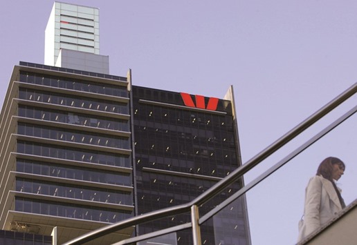 A woman walks on a bridge past the Westpac Banking Corp headquarters in Sydney. Last week, Westpac became the second Australian lender after ANZ Banking Group to be dragged to court by regulators over suspected rigging of benchmark interest rates.
