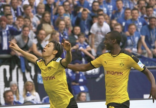 Borussia Dortmundu2019s Shinji Kagawa celebrates with Adrian Ramos after scoring a goal yesterday.