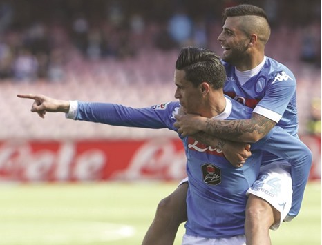 Napoliu2019s Jose Maria Callejon (L) celebrates with teammate Lorenzo Insigne after scoring against Verona yesterday.