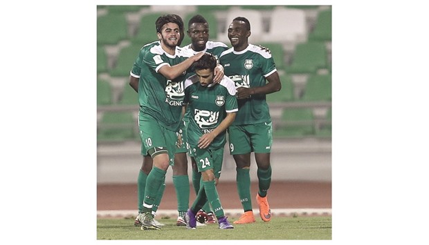 Al Ahli players Ali Ahmed Ghaderi (L) and  hat-trick hero Mouhssine Iajour (R) congratulate Mohsin Yazeedi (C) after he scored his teamu2019s fourth goal against Lekhwiya yesterday.