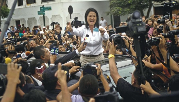 Peruu00b4s presidential candidate, Keiko Fujimori, waves upon arrival at the voting station during general elections, in Lima yesterday.