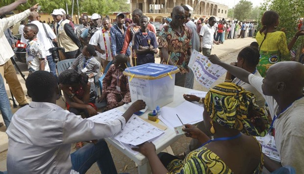 Chadians wait in line to cast votes in the presidential election at a polling station in Nu2019Djamena.