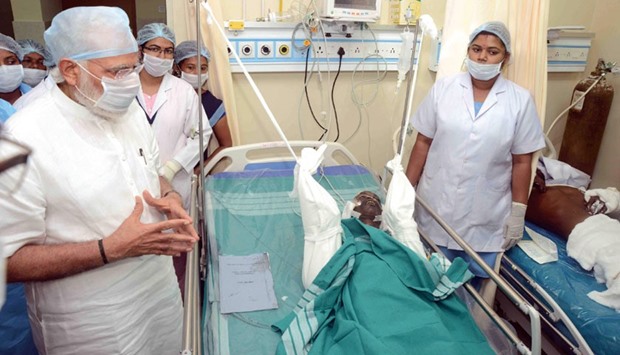 Prime Minister Narendra Modi visits an injured patient at the Thiruvananthapuram Medical College Hospital.