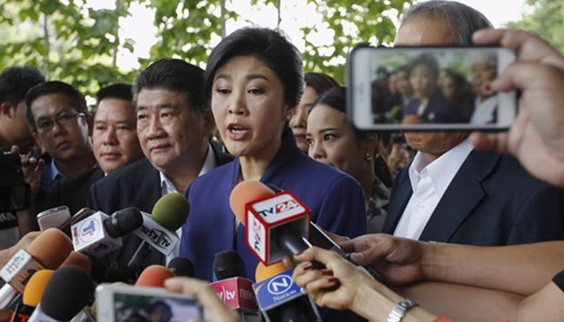 Former Thai prime minister Yingluck Shinawatra speaks to media as she arrives at the Supreme Court for a trial in Bangkok on Friday.