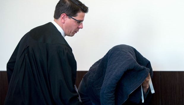 Defendant Tufik M (R) arrives with his lawyer Markus Wittke (L) at the court in Duesseldorf, western Germany. AFP