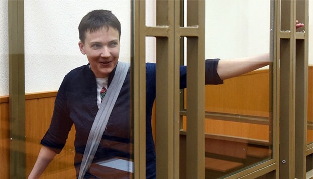 Ukrainian military pilot Nadiya Savchenko looking out from a defendants' cage after the first day of the verdict announcement at a court in the southern Russian town of Donetsk, on March 21, 2016.