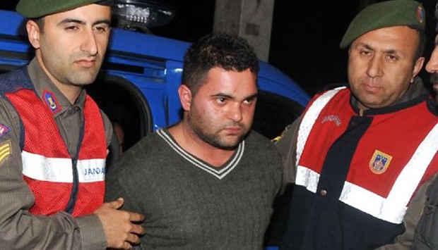 Ahmet Suphi Altindoken (M) being led away during the trial in 2015 December.