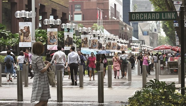 Pedestrians walk along the Orchard Road shopping district in Singapore. South East Asian growth is forecast to slow from 6.5% in 2015 to 6.3% this year and 6.2% in 2017 and 2018, the World Bank said in its latest outlook yesterday.