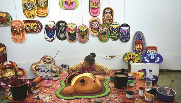 A Bangladeshi Dhaka University Art Institute student paints masks to sell as part of Bengali New Year preparations in Dhaka yesterday. The Bengali calendar is solar, with the year beginning on Pohela Boishakh, which this year falls on April 14, in Bangladesh.