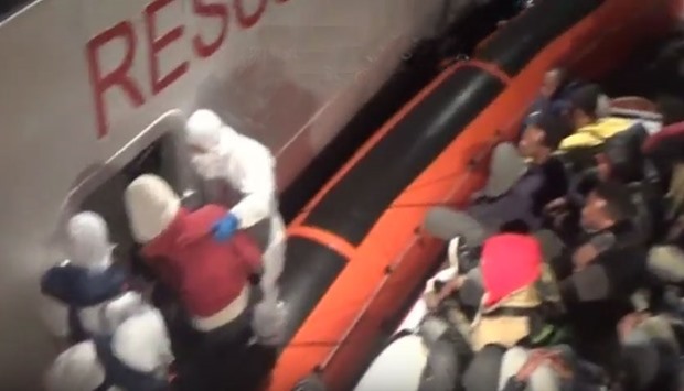 Migrants are being taken to a coastguard vessel vessel from a dingy