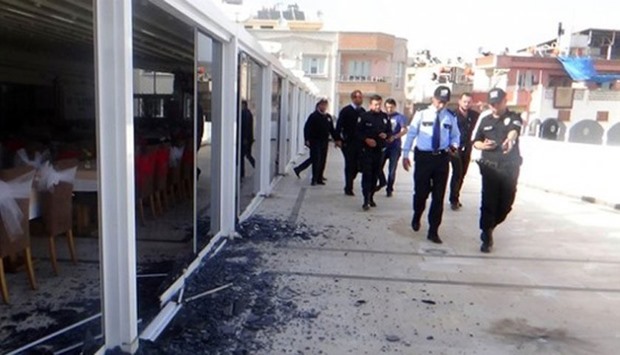 Security personal inspects a hotel premises in Kilis where a from Syria has fallen.