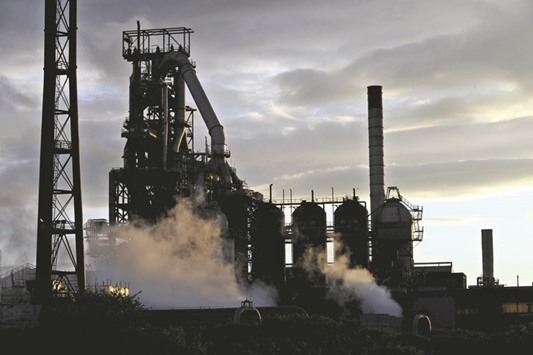 One of the blast furnaces of the Tata Steel plant is seen at sunset in Port Talbot, South Wales. The Indian firm yesterday agreed to sell part of its British business to investment firm Greybull Capital, preventing thousands of job losses, and freeing it up to focus on the sale of its other big plant, in Wales.